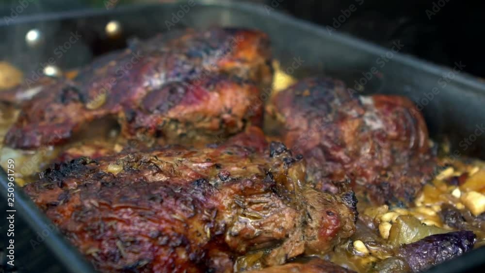 Slow Motion of chef cooking pork being grilled on barbecue. Very delicious roast pig meat on a BBQ grill in backyard. Food cooked with grilling BBQ in the garden of a house-Dan Slow Motion of chef cooking pork being grilled on barbecue. Very delicious roast pig meat on a BBQ grill in backyard. Food cooked with grilling BBQ in the garden of a house-Dan