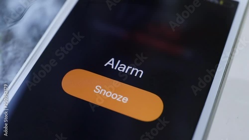 Smartphone with Alarm Clock on Display. shake on table