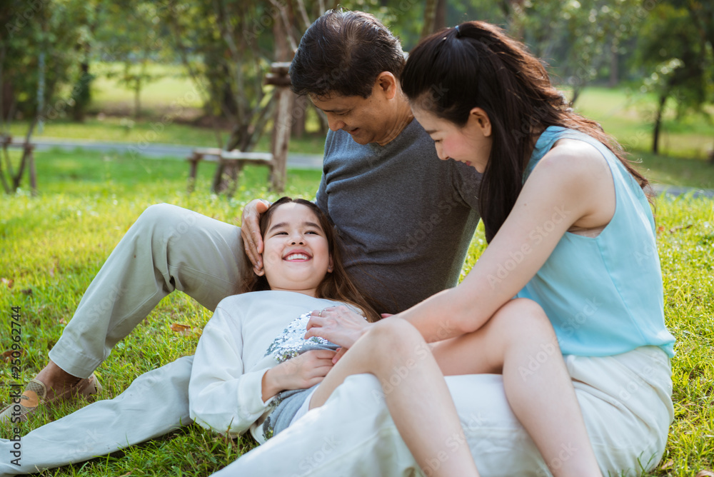 The daughter laying down on her parents The daughter laying down on her parents