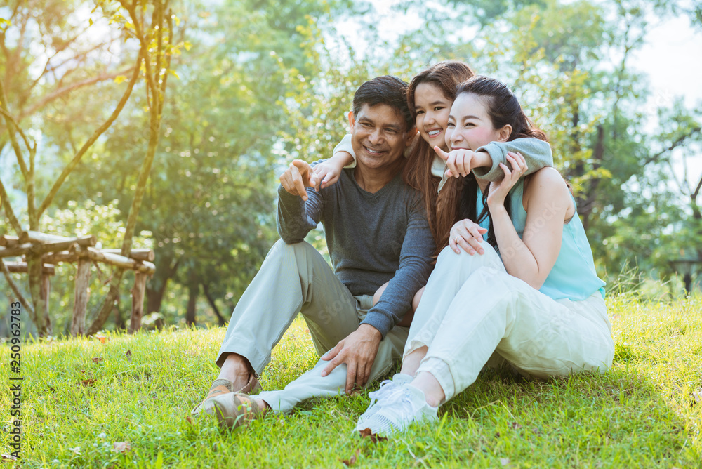 A happy family sitting in the park A happy family sitting in the park
