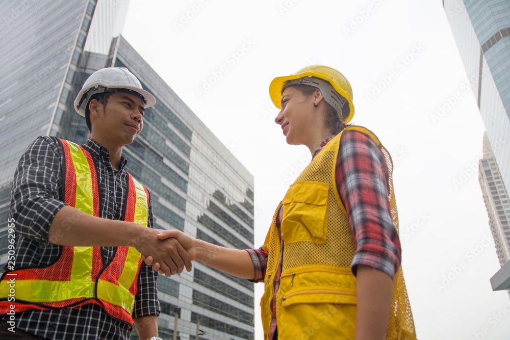 Engineerss shake hands to celebrate success day Engineerss shake hands to celebrate success day