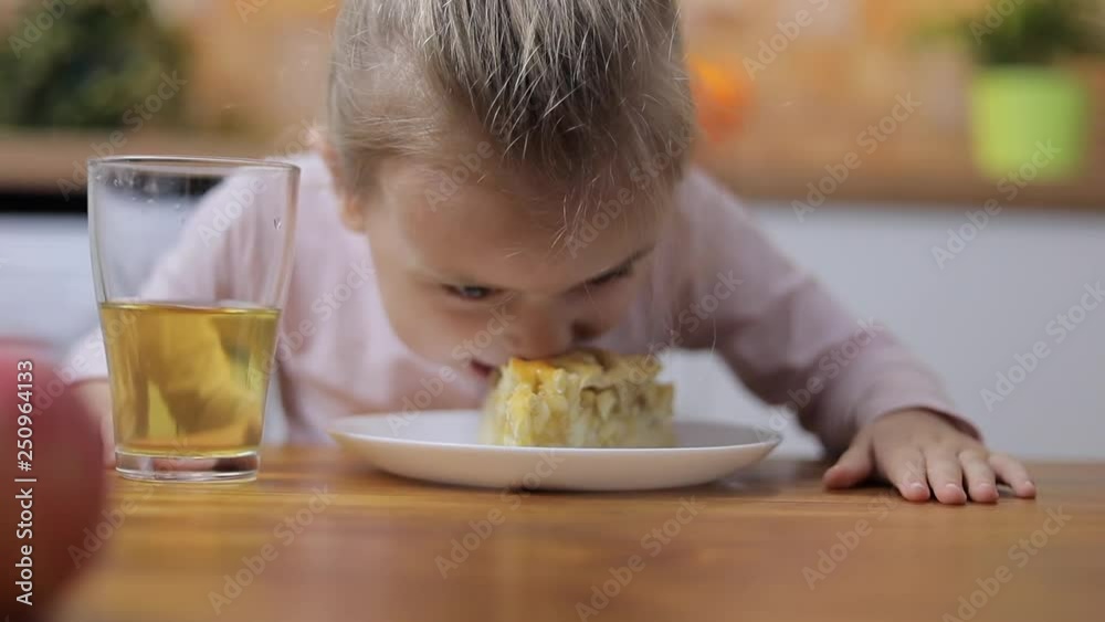 Little girls and boys eating homemade apple pie and drinking juice Little girls and boys eating homemade apple pie and drinking juice