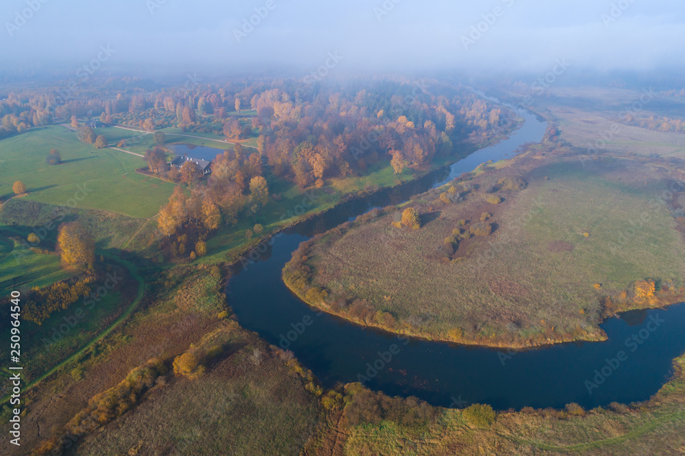 View of the Trigorskoe and the Sorot river on a cloudy October morning (aerial photography). Pushkin Mountains, Russia