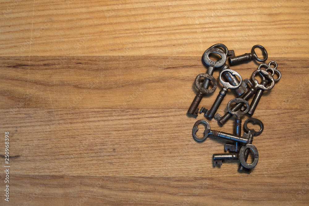 Grouping of Old Skeleton Keys Laying on a Wood Table Grouping of Old Skeleton Keys Laying on a Wood Table