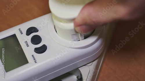 Electrical appliances plugs and wattmeter are inserted into an electrical extension cord closeup