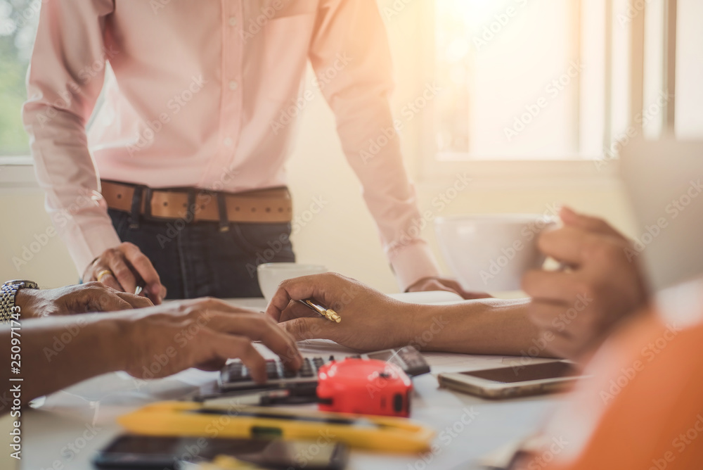 Close up hand of civil engineer or architect business working on blueprint architectural project at construction site at desk in office. Close up hand of civil engineer or architect business working on blueprint architectural project at construction site at desk in office.