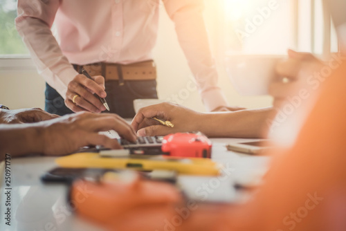 Architect or engineer team working with blueprints building plan design project in office Construction engineering tools and structure concept.