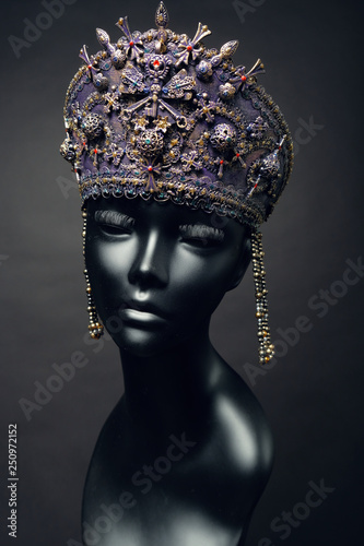 Black head of mannequin in creative metallic kokoshnick