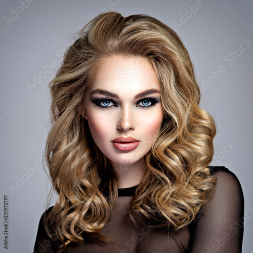 Beautiful blonde girl with makeup in style smoky eyes.