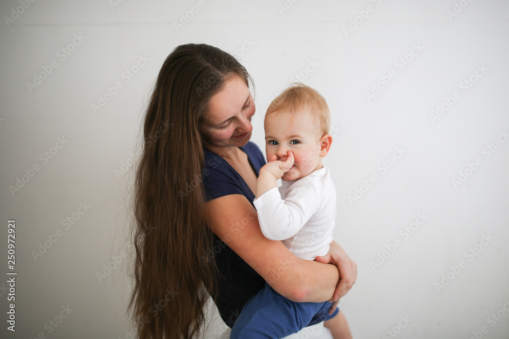 Mom holds the baby in her arms, gently hugs Mom holds the baby in her arms, gently hugs