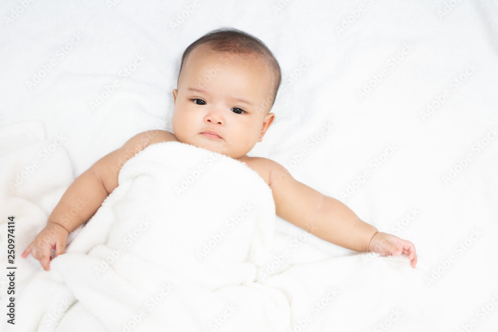 Happy Asian newborn baby under white towel after bath Happy Asian newborn baby under white towel after bath