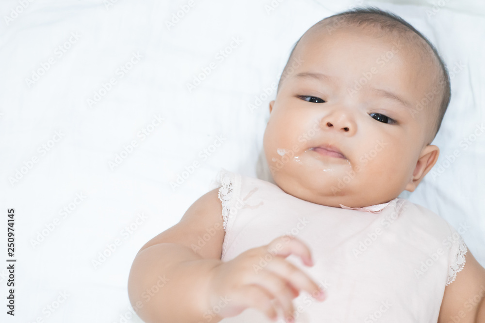 Asian newborn baby is vomitting or overfeeding. Close up baby girl vomit on white background. Asian newborn baby is vomitting or overfeeding. Close up baby girl vomit on white background.