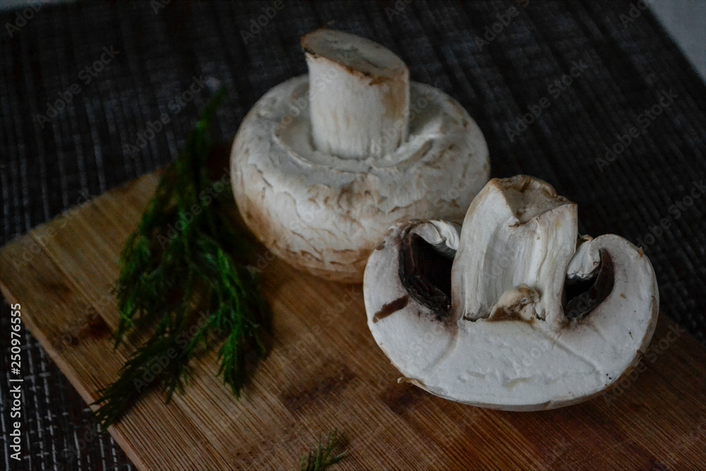 fresh mushrooms with herbs on a cutting board
