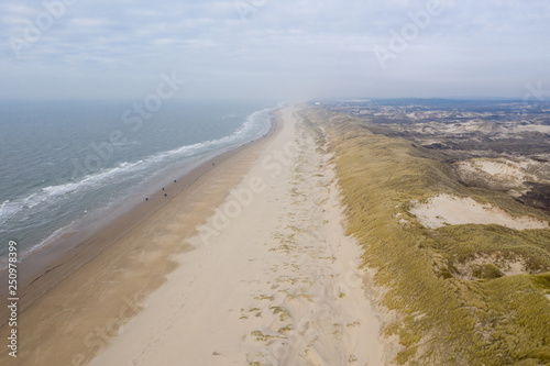 Dutch dunes by the sea from above in mystical late afternoon sun