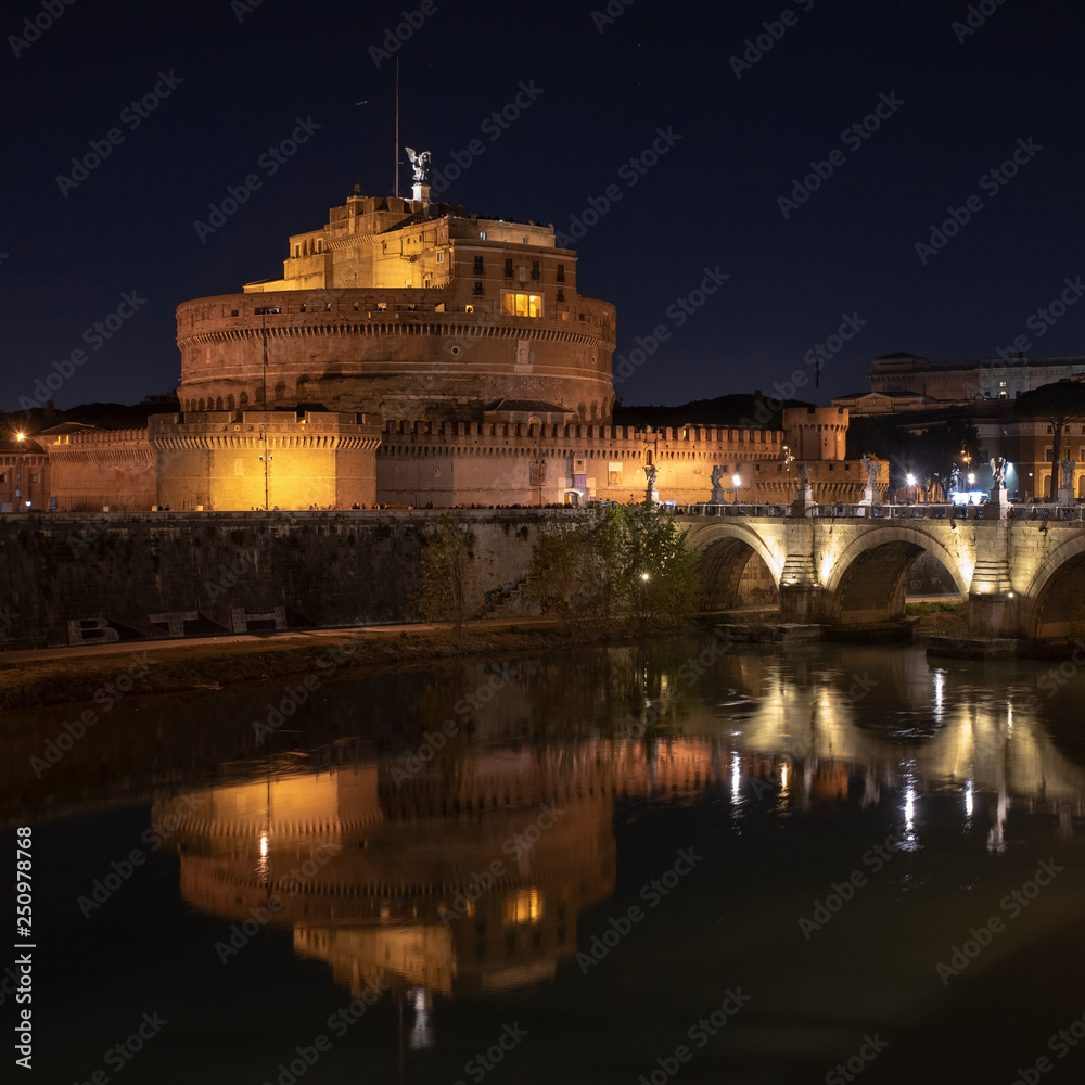 Rome Italy. Beautiful view of Castel Sant'Angelo and the bridge at night with reflections on the Tiber river.