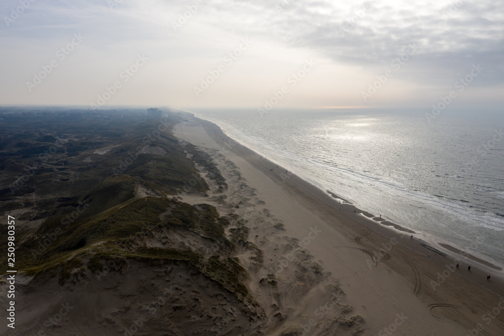 Dutch dunes by the sea from above in mystical late afternoon sun Dutch dunes by the sea from above in mystical late afternoon sun