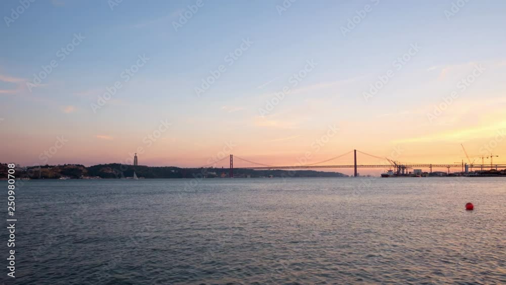 Timelapse view of suspension bridge 25 de Abril on river Tagus at sunset time, Lisbon, Portugal. Timelapse view of suspension bridge 25 de Abril on river Tagus at sunset time, Lisbon, Portugal.