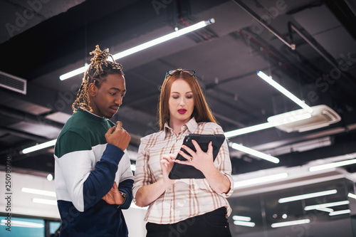 multiethnic business couple using a tablet computer