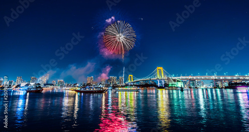 city skyline view of tokyo bay, firework, rainbow bridge photo