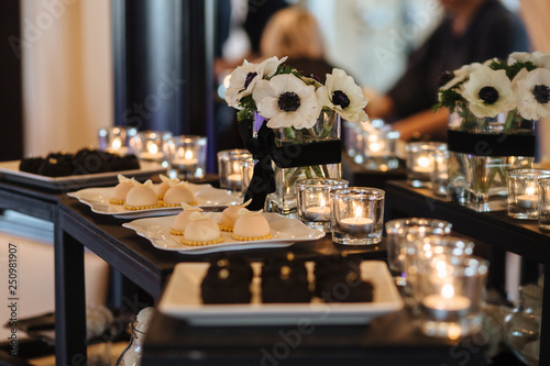 Sweet table. A plates of cakes and muffins with cream. Table with sweets, candy, buffet. Dessert table for a party goodies for the wedding. Close up. candy bar. Decorated delicious
