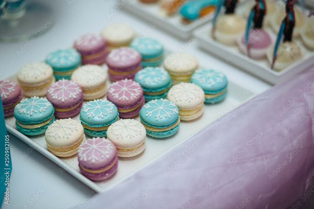 Sweet table. A plates of cakes and muffins with cream. Table with sweets, candy, buffet. Dessert table for a party goodies for the wedding. Close up. candy bar. Decorated delicious Sweet table. A plates of cakes and muffins with cream. Table with sweets, candy, buffet. Dessert table for a party goodies for the wedding. Close up. candy bar. Decorated delicious