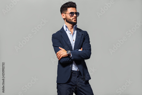 Elegant young handsome man in suite wearing glasses. Studio fashion portrait.