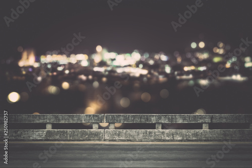 View from empty concrete bridge above the town at night.