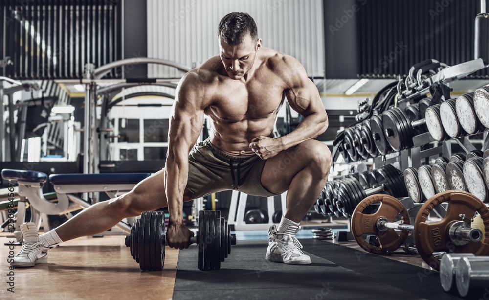 Fototapeta premium guy bodybuilder with dumbbell