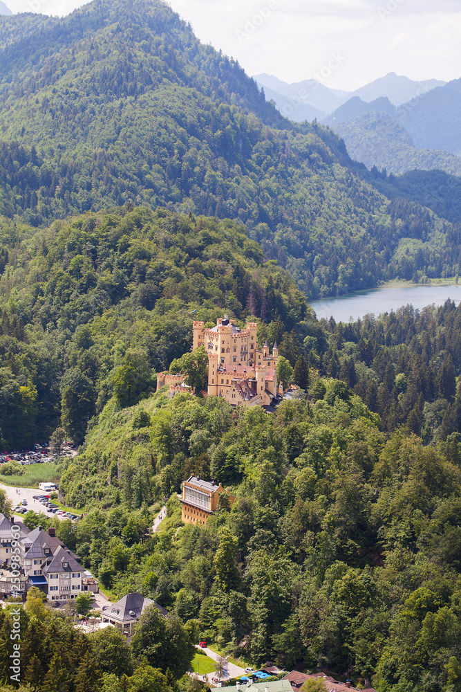 View from the air to the Schloss Hohenschwangau castle in the Alpine mountains