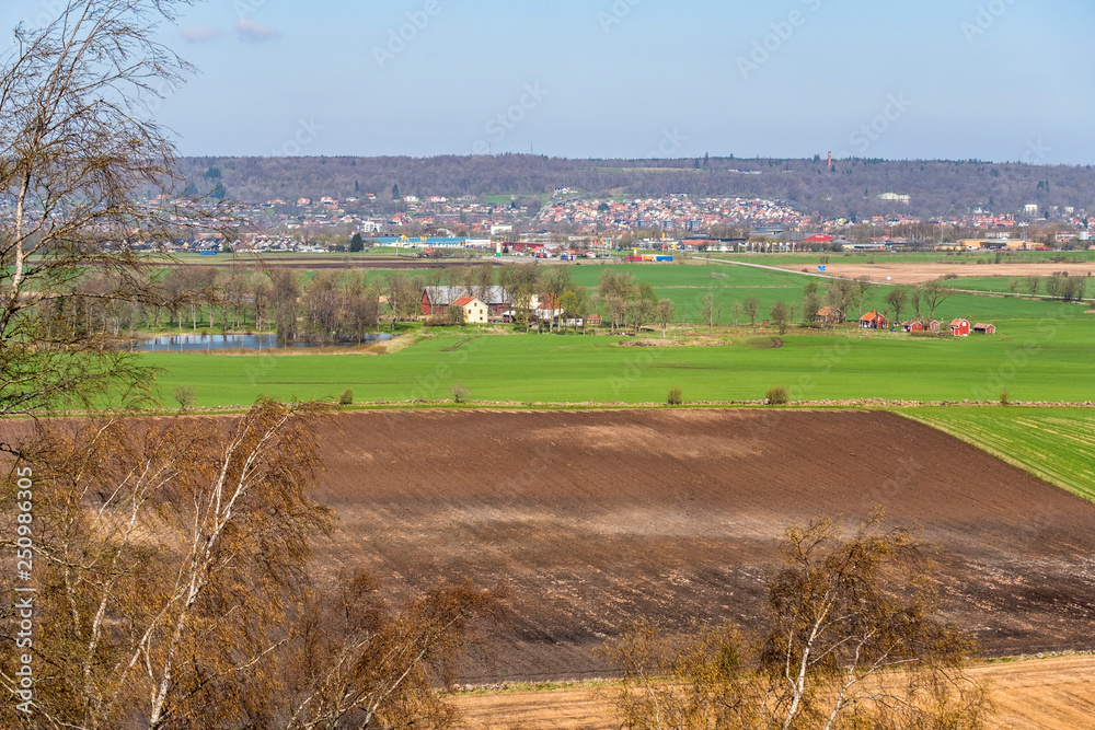 Landscape view of the fields towards a city in the spring
