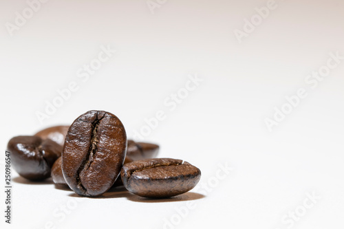 Pile of roasted coffee beans. On white background