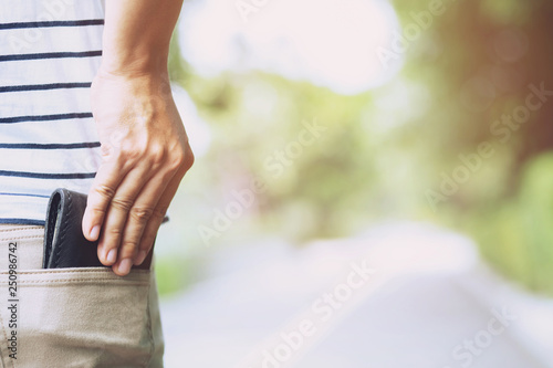 Confident man posing in safe keeping your wallet in the back pocket of his back pocket pants. savings money finance. 