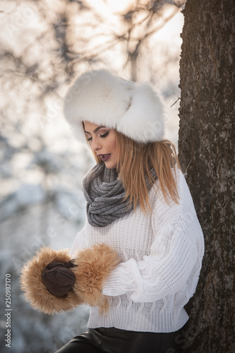 Fotografija Attractive woman with white fur cap and jacket enjoying the winter
