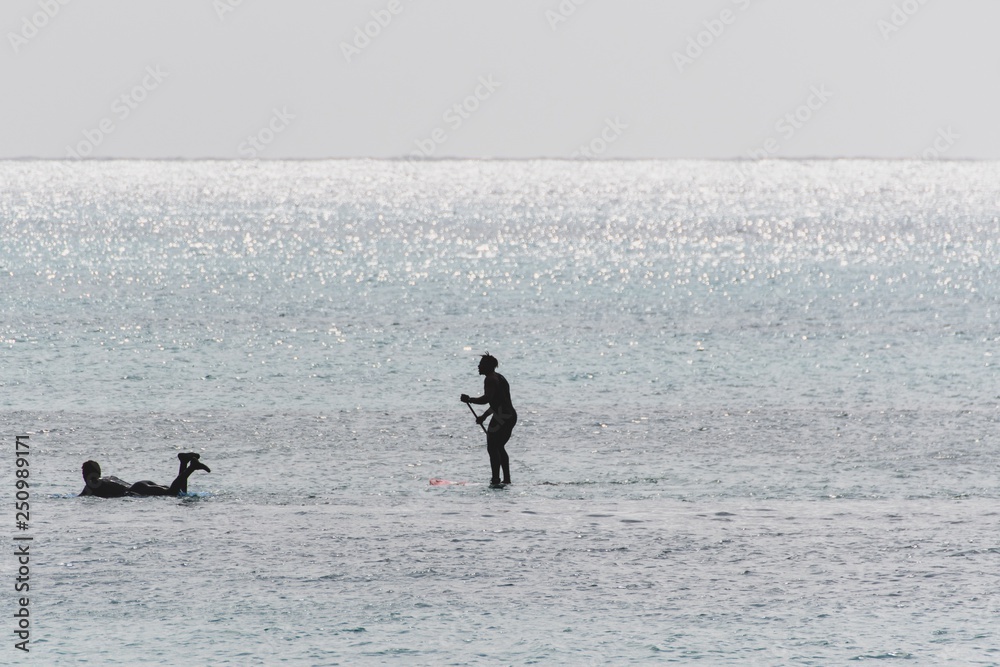 Capo Verde beach scene SUP and surfer