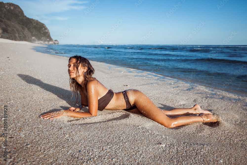 sexy girl in brown swimsuit sunbathing on the beach sexy girl in brown swimsuit sunbathing on the beach