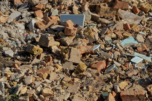 stone texture from garbage pieces of brown bricks and tiles in a pile on the ground