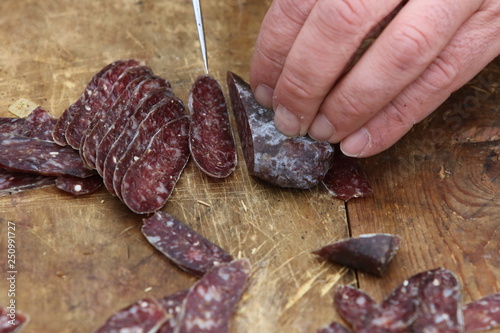 Lukanka is a Bulgarian salami unique to Bulgarian cuisine. Lukanka is semi-dried, has a flattened cylindrical shape, and brownish-red interior in a skin that is normally covered with a white fungus photo