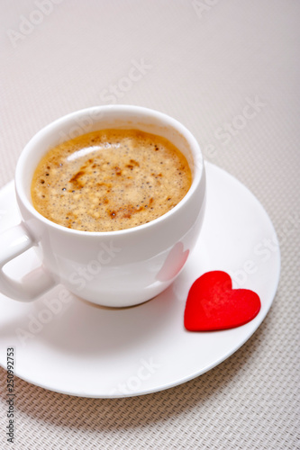 a white cup with espresso coffee and red heart like a cocept love for coffee