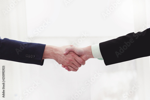 close up.handshake of financial partners on desktop background © yurolaitsalbert