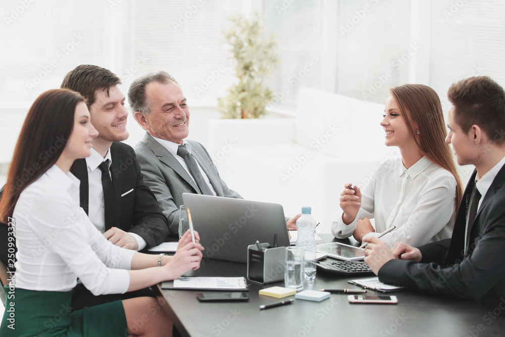 business colleagues talking at Desk in the office business colleagues talking at Desk in the office