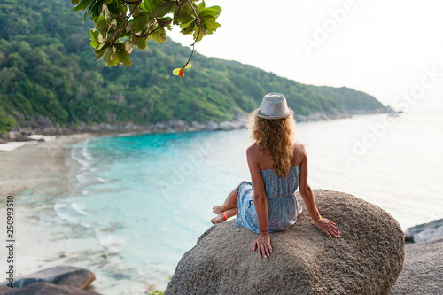 Happy traveler woman in blue dress relaxing beautiful nature landscape island. Tourist sea beach Thailand, Asia. Summer vacation travel trip. Back view