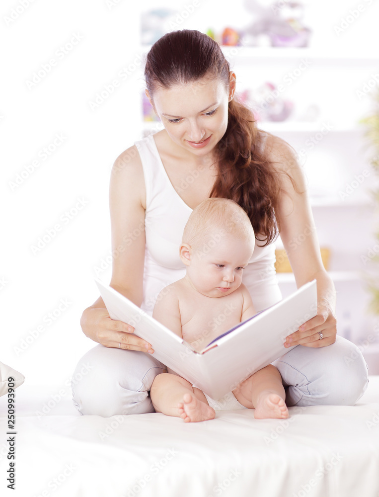 charming mom reading a book to her baby charming mom reading a book to her baby