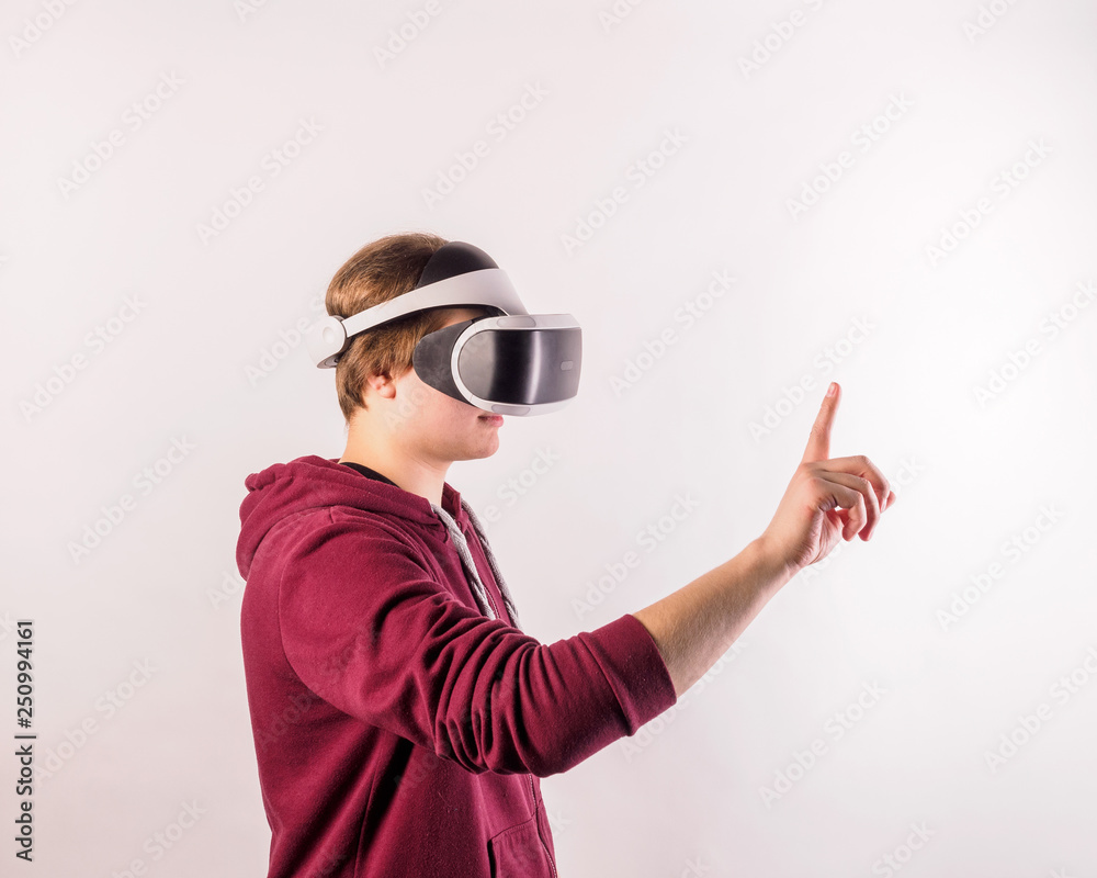 Teenage student man virtual reality headset or 3d glasses, playing video game, gesturing with his hands and catching something. Teenage student man virtual reality headset or 3d glasses, playing video game, gesturing with his hands and catching something.
