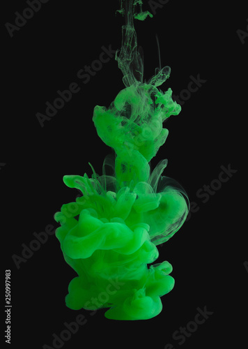 Green paint splash cloud in water, isolated on black