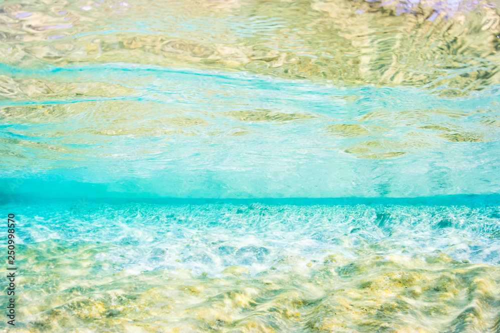 Light blue and gold coloured underwater abstract of shallow Mediterranean sea