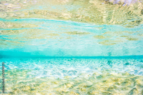 Light blue and gold coloured underwater abstract of shallow Mediterranean sea