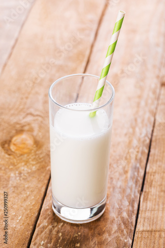 Glass of Milk and Straw on Wooden Table