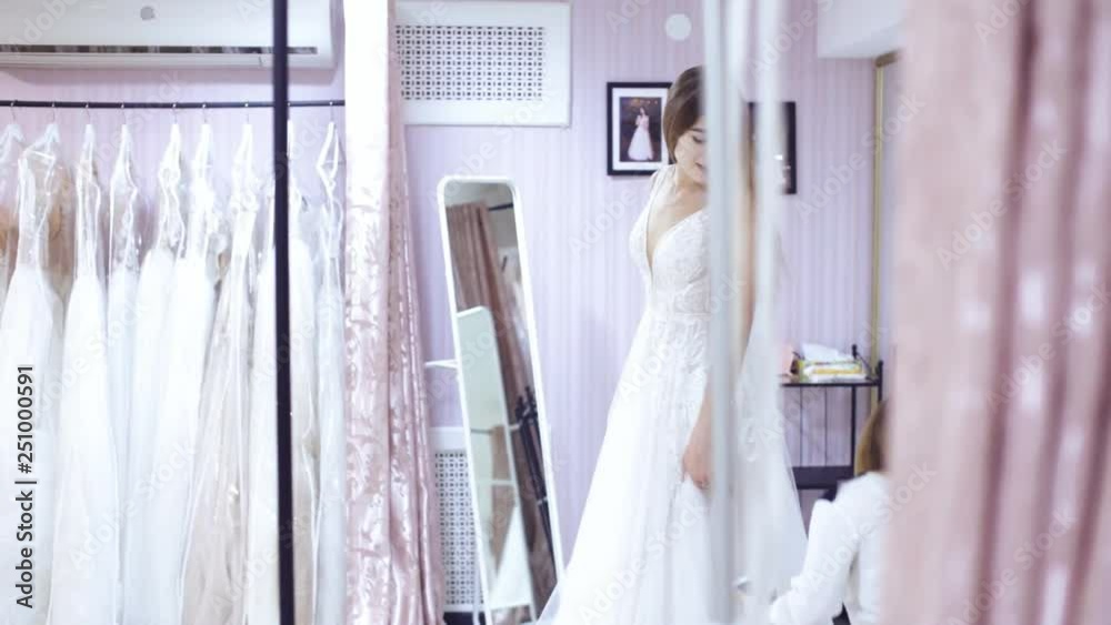 girl tries on a dress in the wedding shop girl tries on a dress in the wedding shop