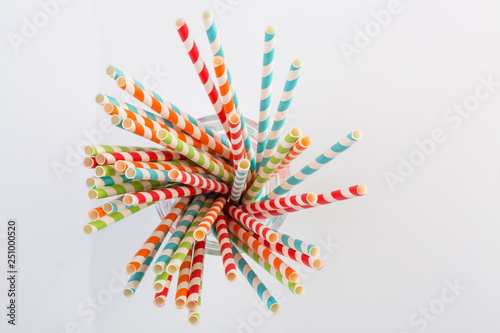 Top view of striped paper straws in a glass