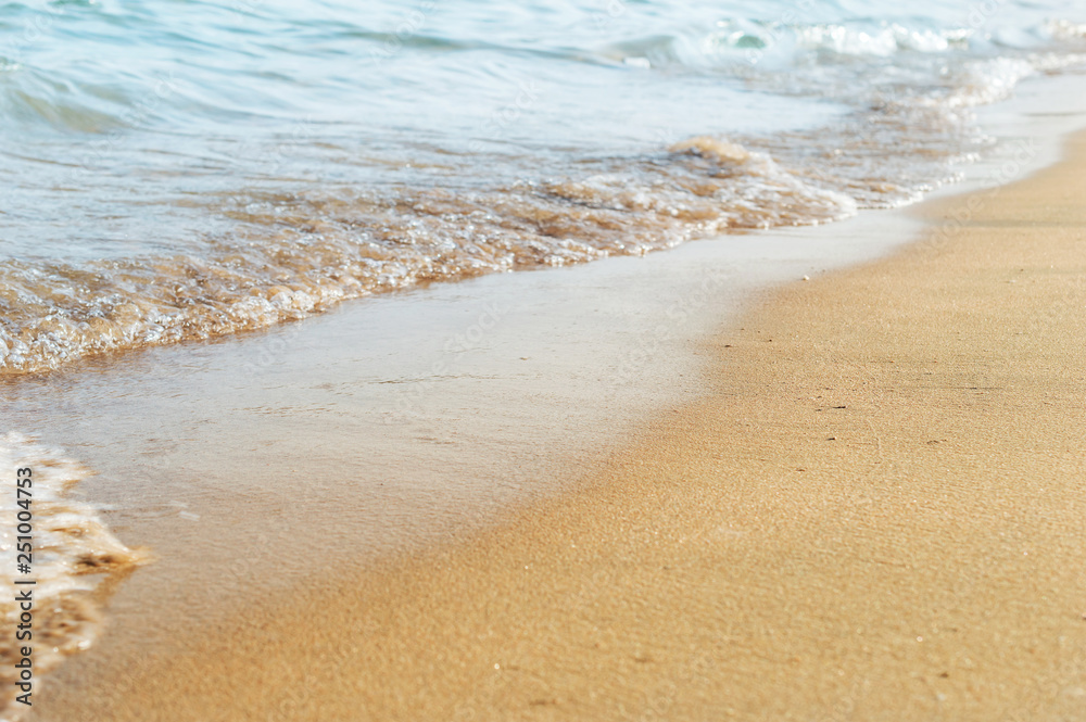 Natural background by sea wave on sand. Vacation and holiday concept.